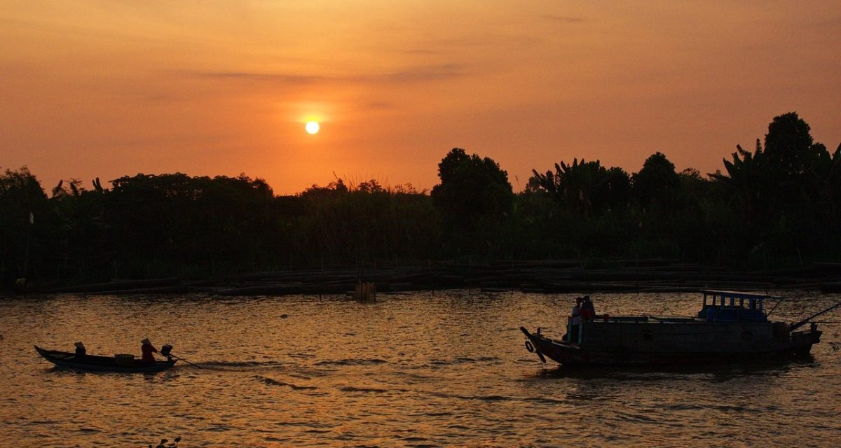 Coucher du soleil sur le Mékong à Vientiane, entre bateaux traditionnels et atmosphère paisible au Laos